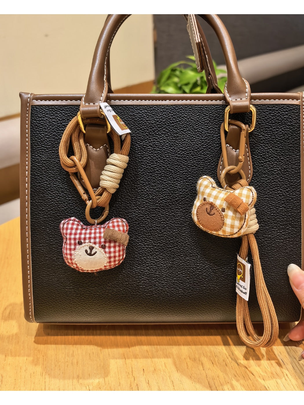 Bear charm keychain attached to a set of keys on a wooden surface