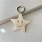 Five pointed star pendant keychain shown from a side angle on a white background