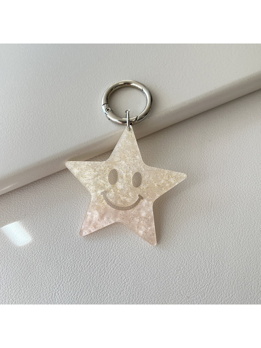 Five pointed star pendant keychain shown from a side angle on a white background