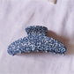 Beau tiny floral acetate claw clip open, showing inner clasp mechanism