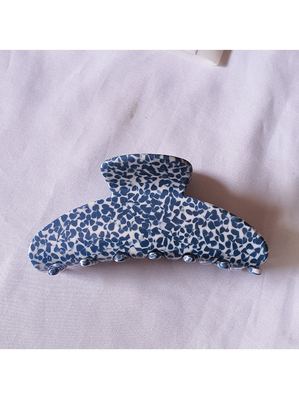 Beau tiny floral acetate claw clip open, showing inner clasp mechanism