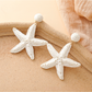 Detailed view of the woven raffia pattern on the starfish stud earrings