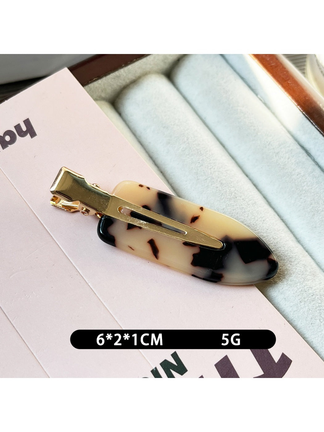 Top view of Beau acetate invisible hair clip showing glossy finish