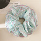 Double layer blue ruffle scrunchie with soft fabric texture