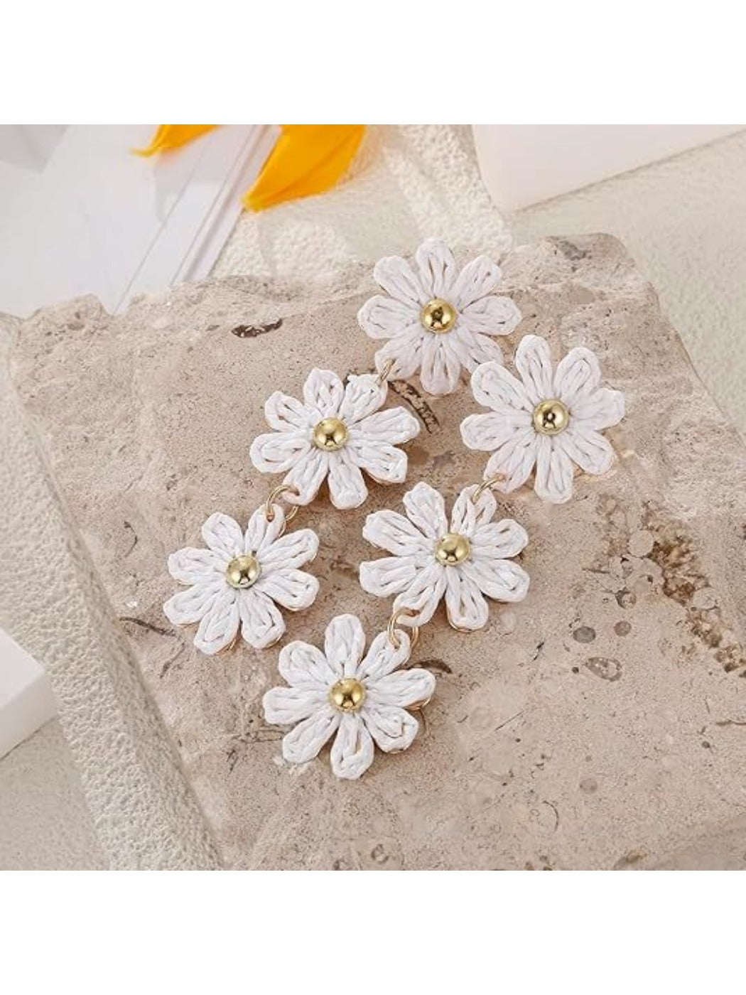 Pair of flower shaped drop earrings with vibrant colors displayed flat