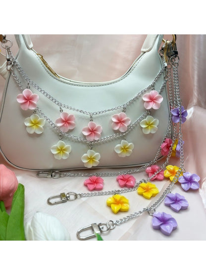 Minimalist flower pendant bag charm with gold chain on white background