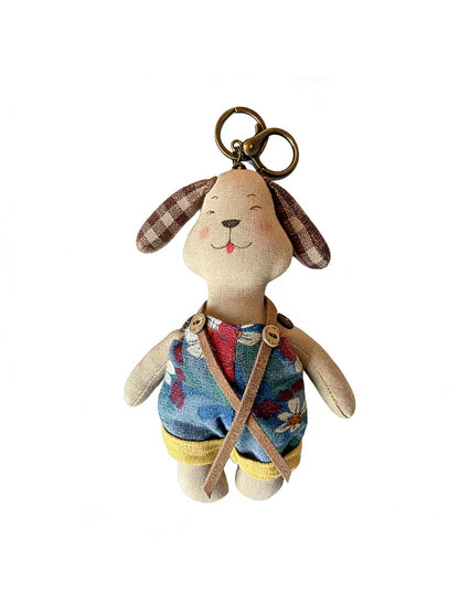 Multiple fabric puppy keychains in different colors arranged on a white background