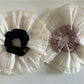 Side view of beige lace scrunchie highlighting intricate lace details
