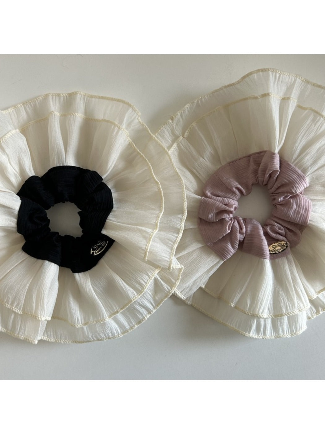 Side view of beige lace scrunchie highlighting intricate lace details