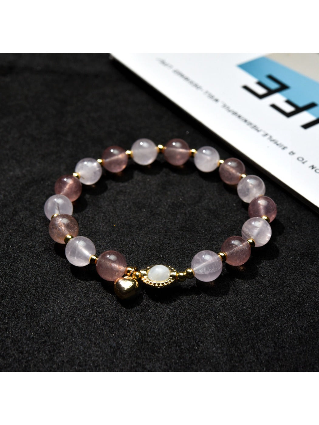 Side view of Lovra beaded bracelet featuring a silver heart charm