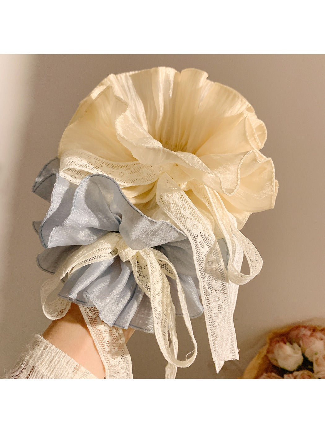 Gifty solid color bow scrunchie in pastel blue displayed on a wooden surface