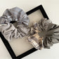 Close-up of Gifty vintage plaid patchwork scrunchie with mixed fabric patterns