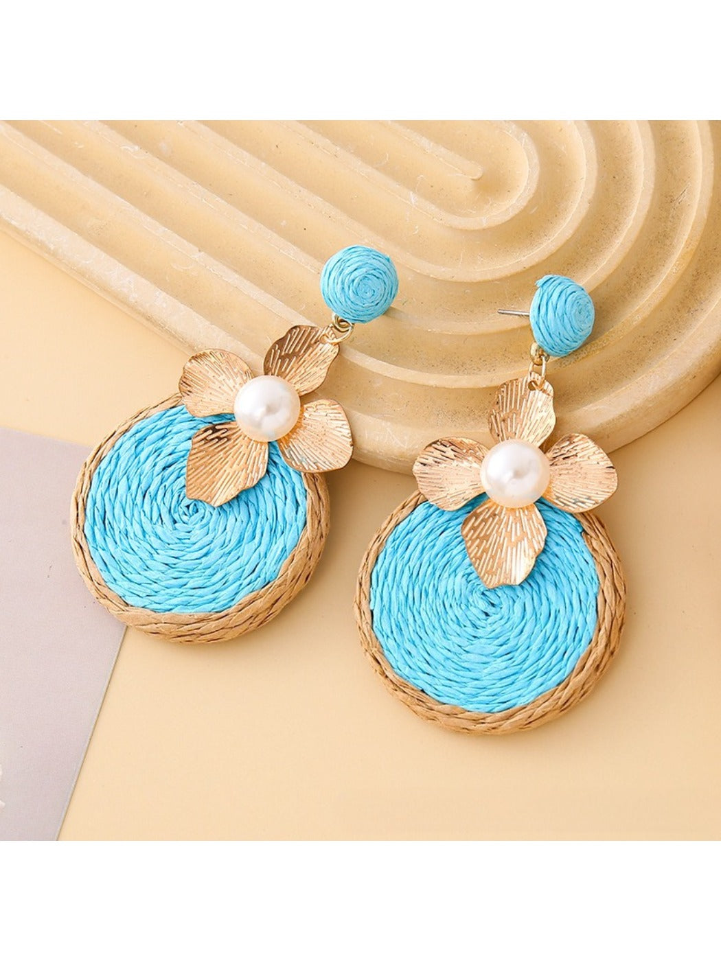 Earedge earrings photographed with soft lighting emphasizing gold floral circles