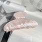 Beau claw clip angled to show teeth alignment and pearlescent coating