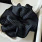 Close-up of Gifty simple daily fashion scrunchie in soft pastel pink fabric