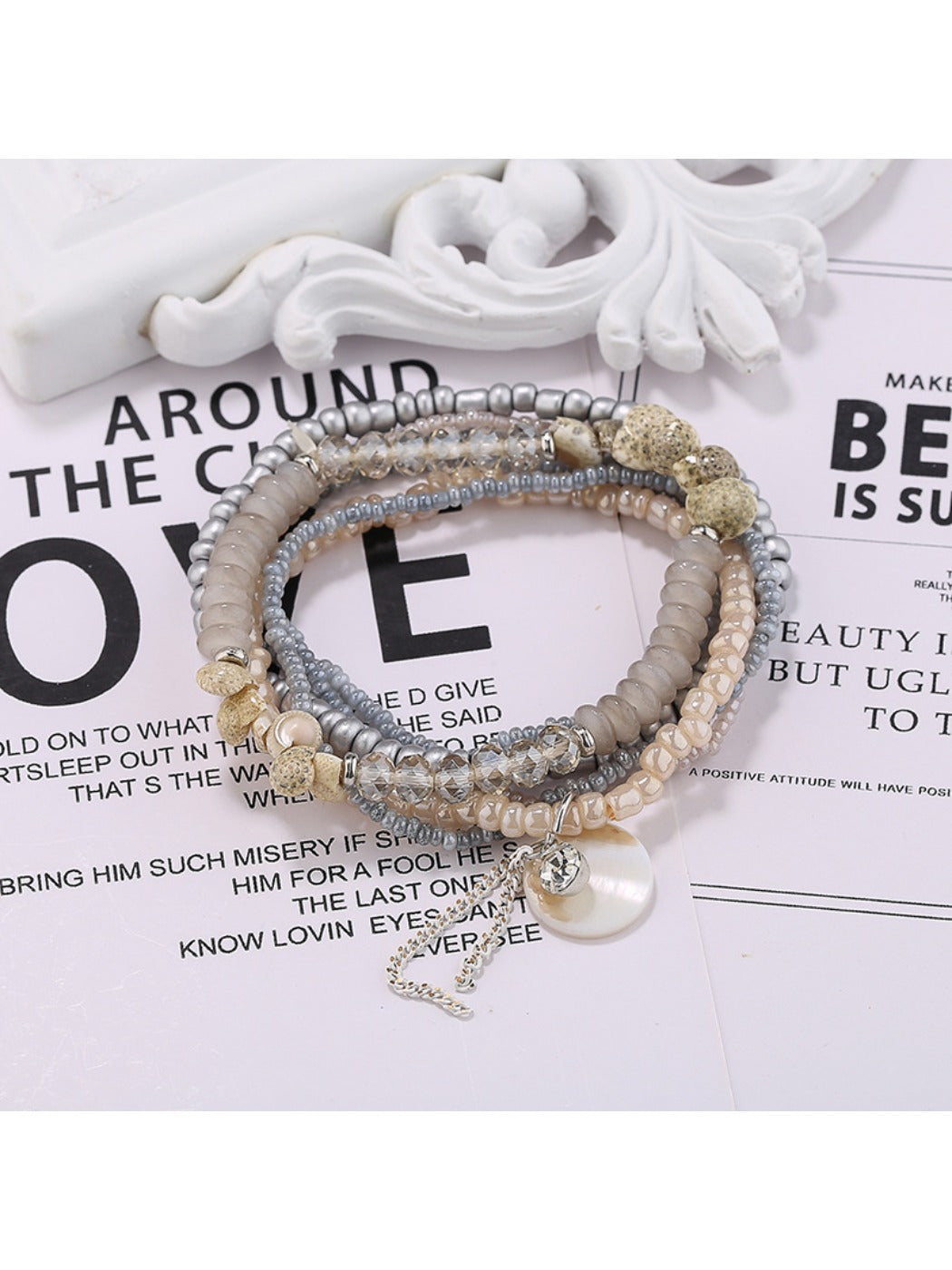 Lovra multi-row bracelet with a mix of pastel and bright beads on a neutral background