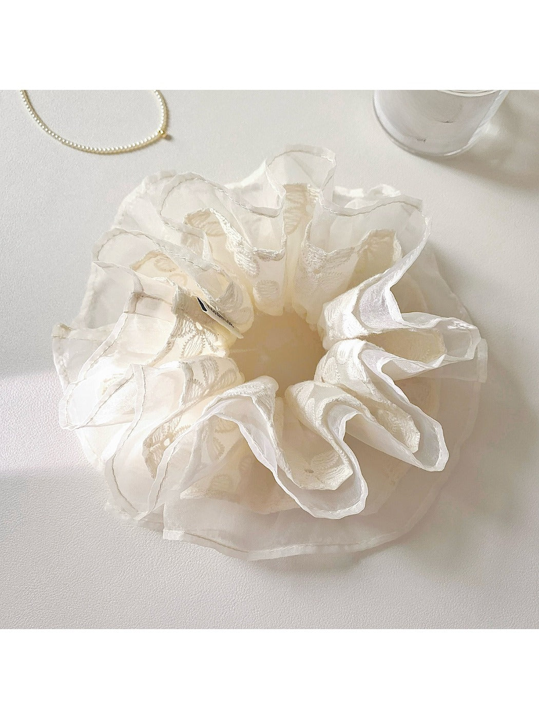 Gifty flower scrunchie displayed on a white background highlighting floral embroidery