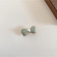 Beau bow hair clip held in hand to show size and detail