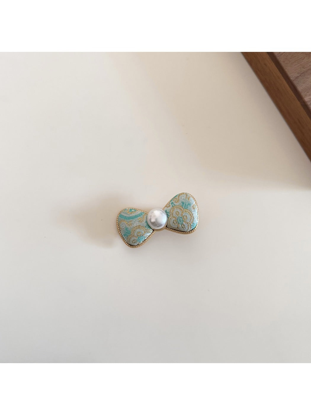 Beau bow hair clip held in hand to show size and detail