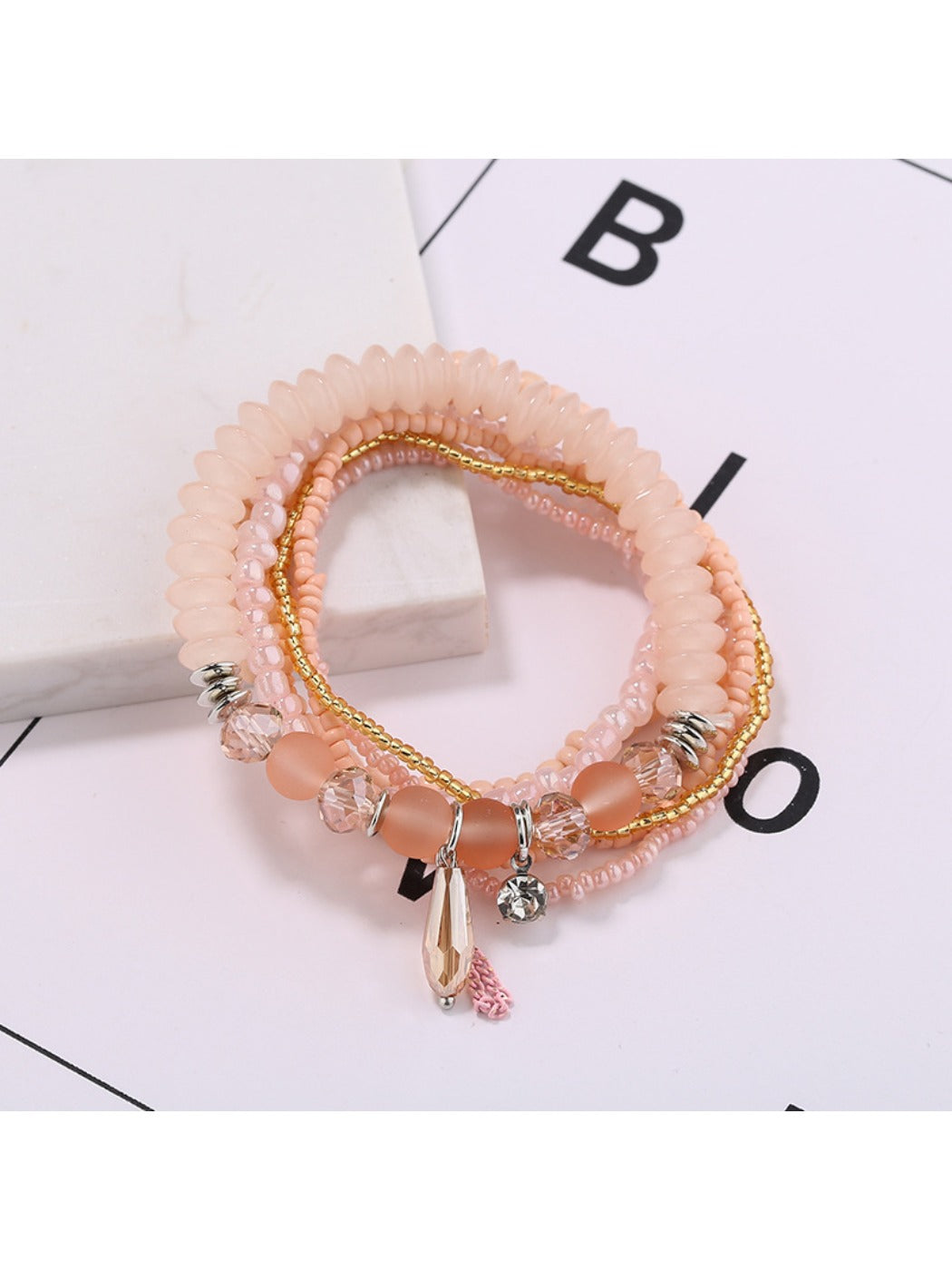 Lovra bracelet with mixed gold and black beads arranged in multiple rows