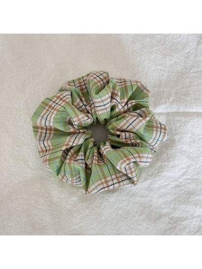Multiple Gifty Sweet Green Style Scrunchies stacked together highlighting fabric details
