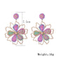 Earedge flower shaped drop earrings worn on a model's ear