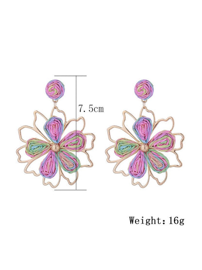 Earedge flower shaped drop earrings worn on a model's ear