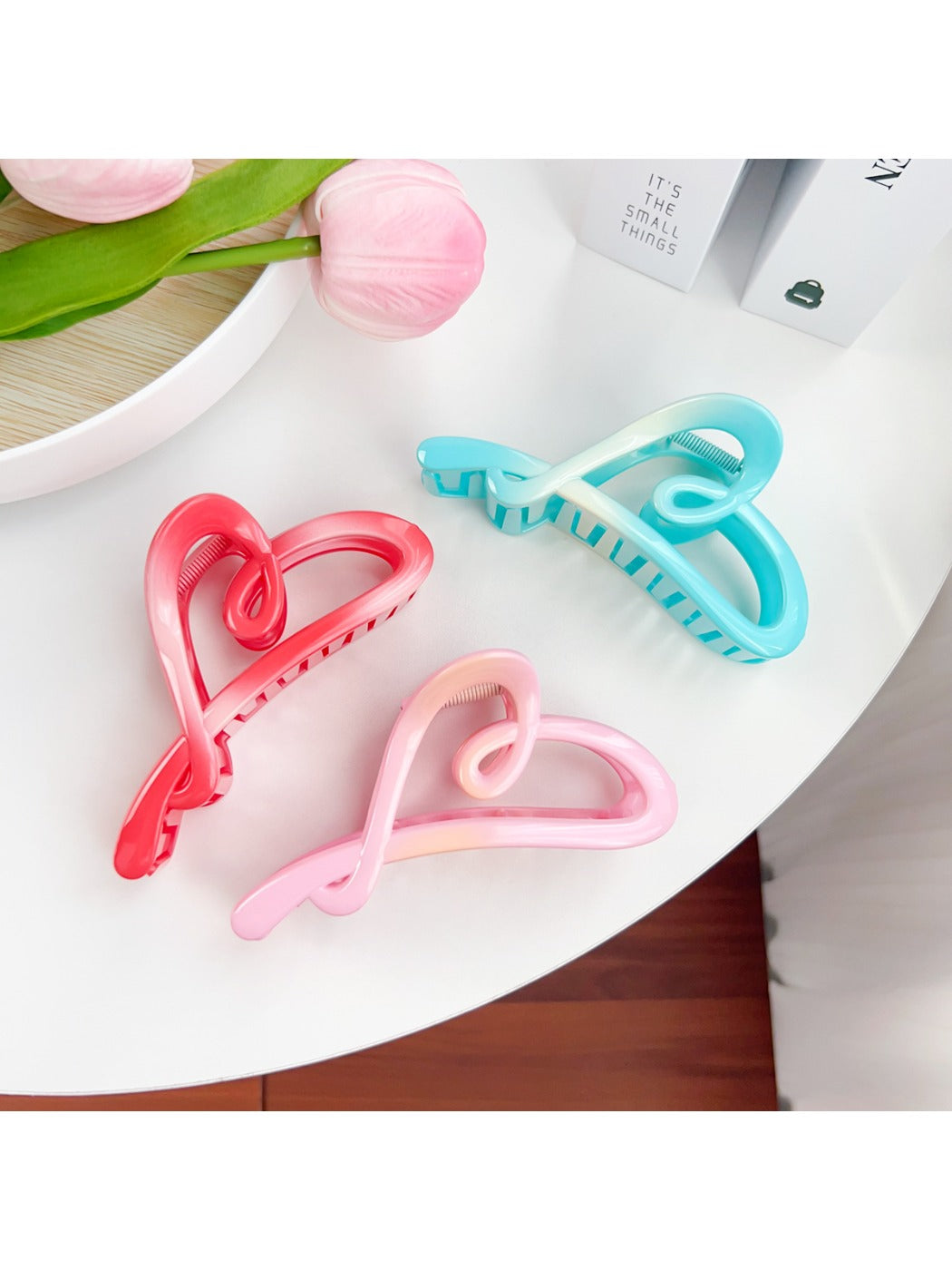 Close-up of Beau heart shaped claw clip showing smooth plastic texture and color contrast