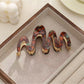 Top view of Beau elegant hair clip showing curved wavy pattern