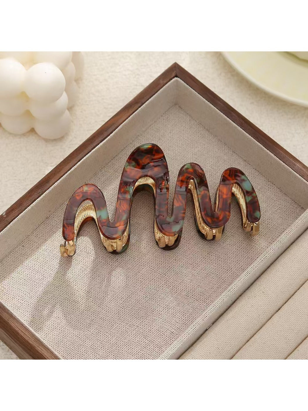 Top view of Beau elegant hair clip showing curved wavy pattern
