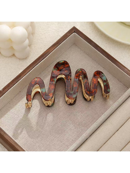 Top view of Beau elegant hair clip showing curved wavy pattern