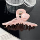 Beau hair claw clip close-up showing colorful flower details and glossy finish