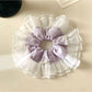 Gifty plaid scrunchie styled on a wrist as a fashion accessory