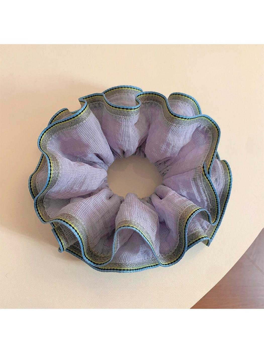 Purple double layer ruffled scrunchie on a white background