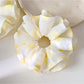 Close-up of yellow polka dot scrunchie fabric texture