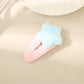Beau fluffy star hair clip held in hand to show size and softness