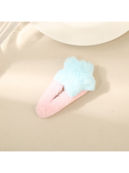 Beau fluffy star hair clip held in hand to show size and softness