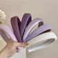 Close-up of purple fabric texture on wide edge headband