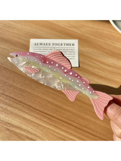 Beau elegant salmon shaped hair claw clip placed on wooden surface