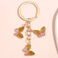 Butterfly keychain hanging from a bag zipper with colorful segmented wings