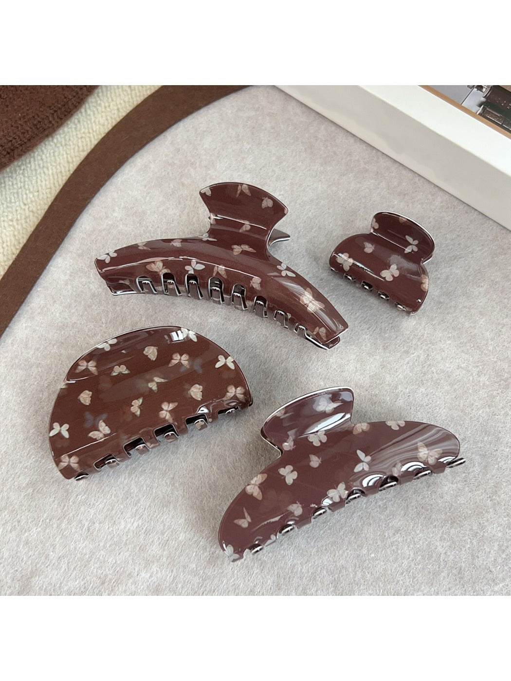 Beau claw clip showing butterfly pattern and curved design