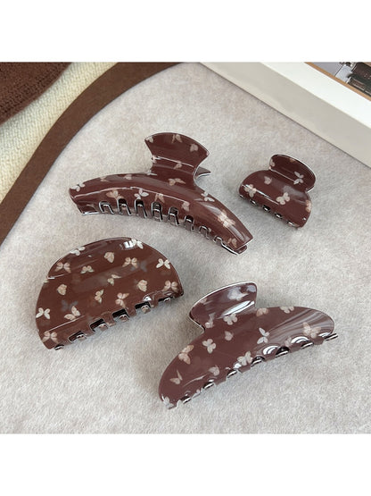 Beau claw clip showing butterfly pattern and curved design