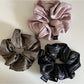 Model wearing vintage pleated fabric scrunchie in hair with casual outfit