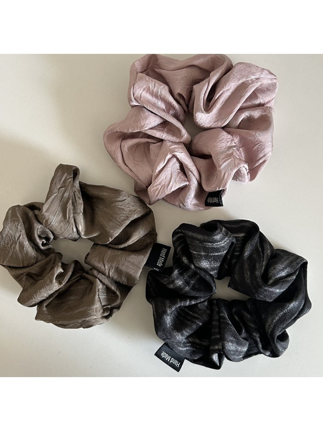 Model wearing vintage pleated fabric scrunchie in hair with casual outfit