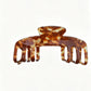 Beau soft acetate claw clip resting on wooden surface with natural light