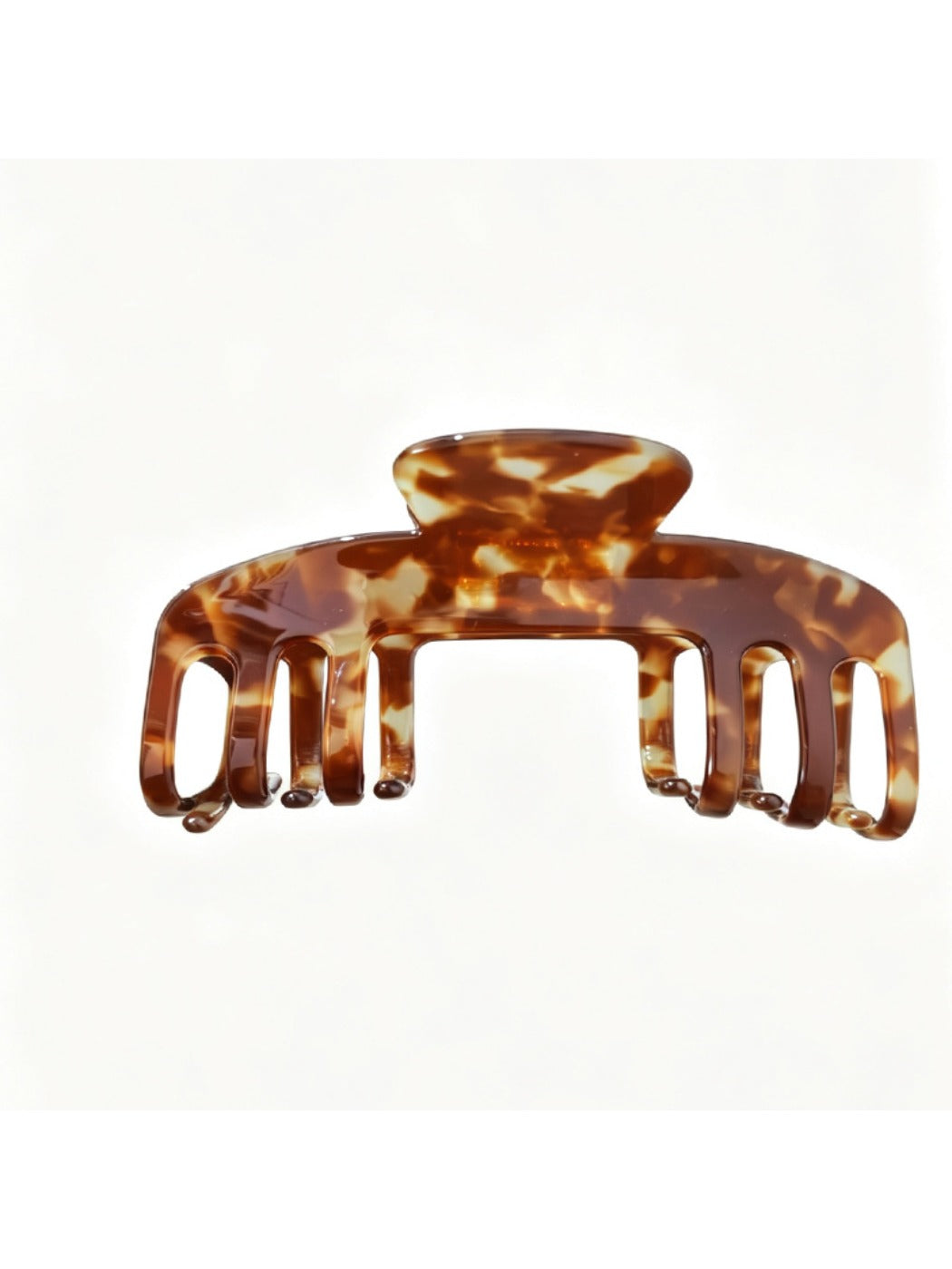 Beau soft acetate claw clip resting on wooden surface with natural light