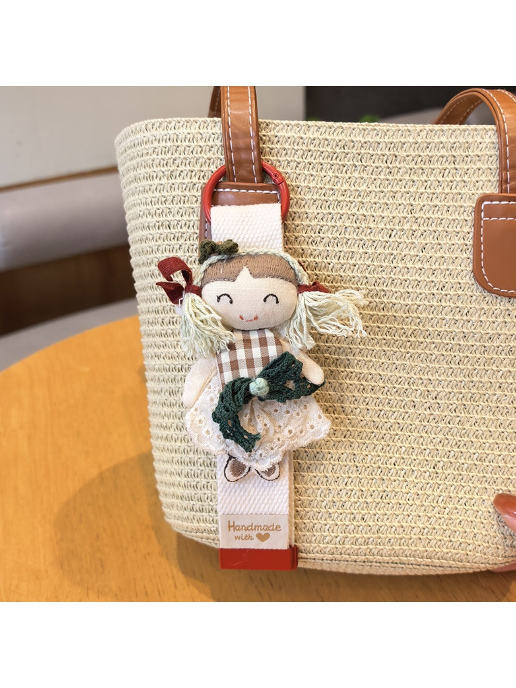 Keypus cute girl charm keychain hanging from a set of keys on a wooden table