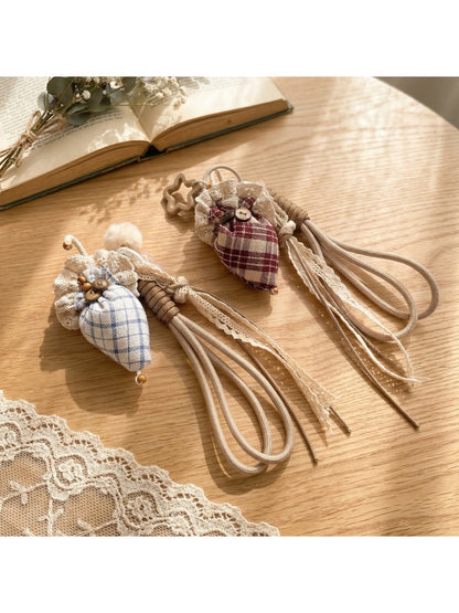 Fabric plaid strawberry umbrella keychain with red and green colors on white background