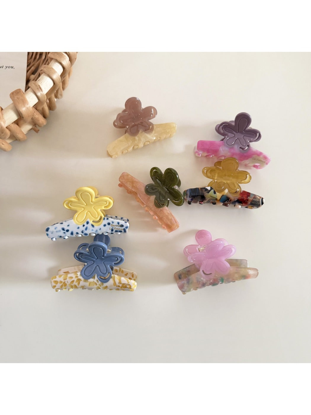 Beau flower shaped hair clip displayed on a white background showing its glossy acetate finish