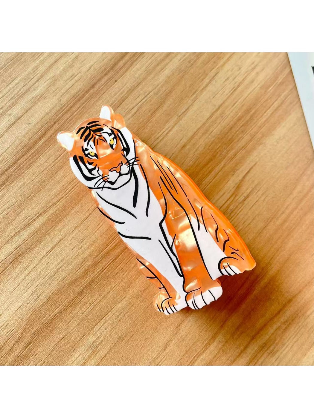 Close-up of Beau tiger shape hair clip with textured tiger stripes